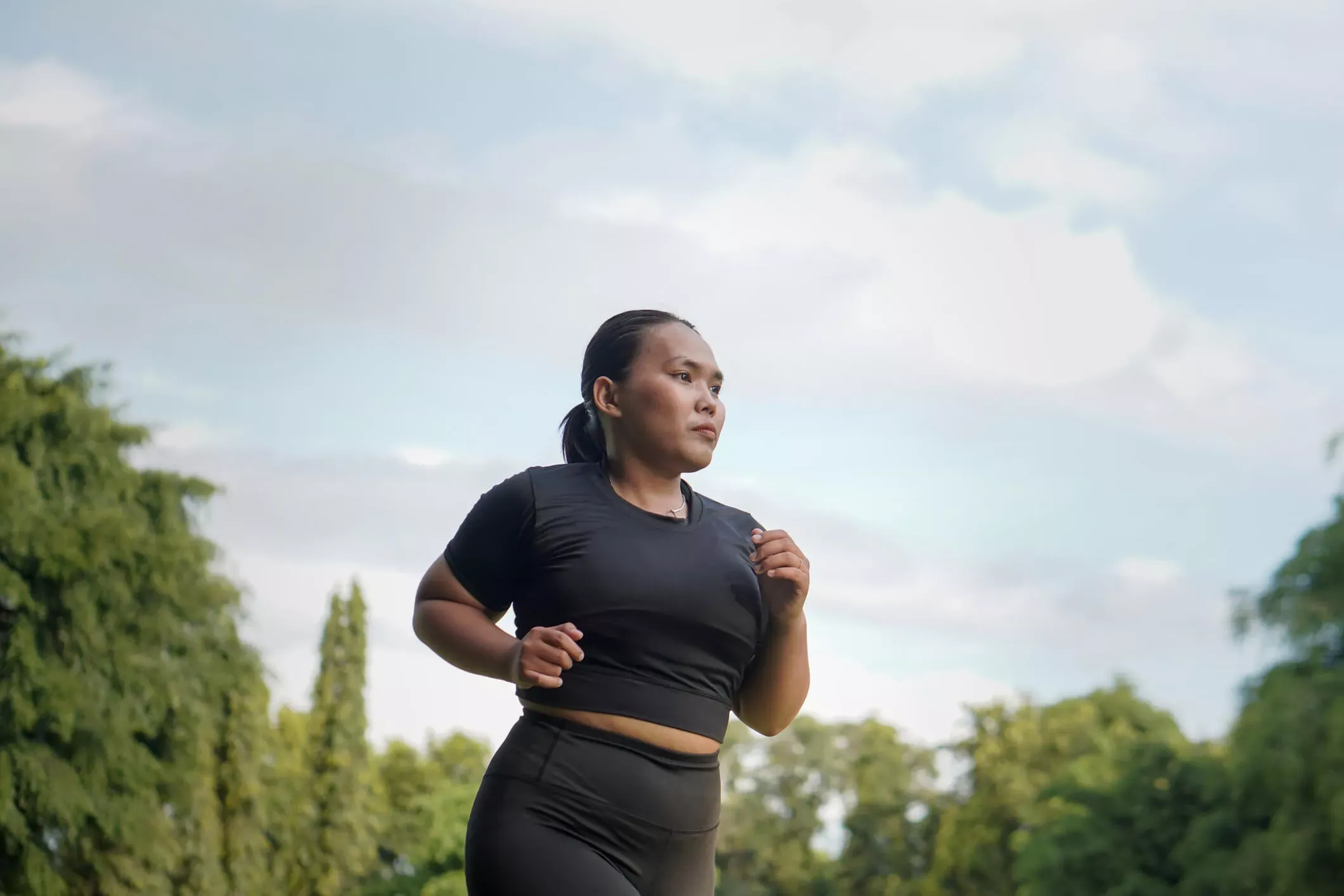 Woman jogging through an open field