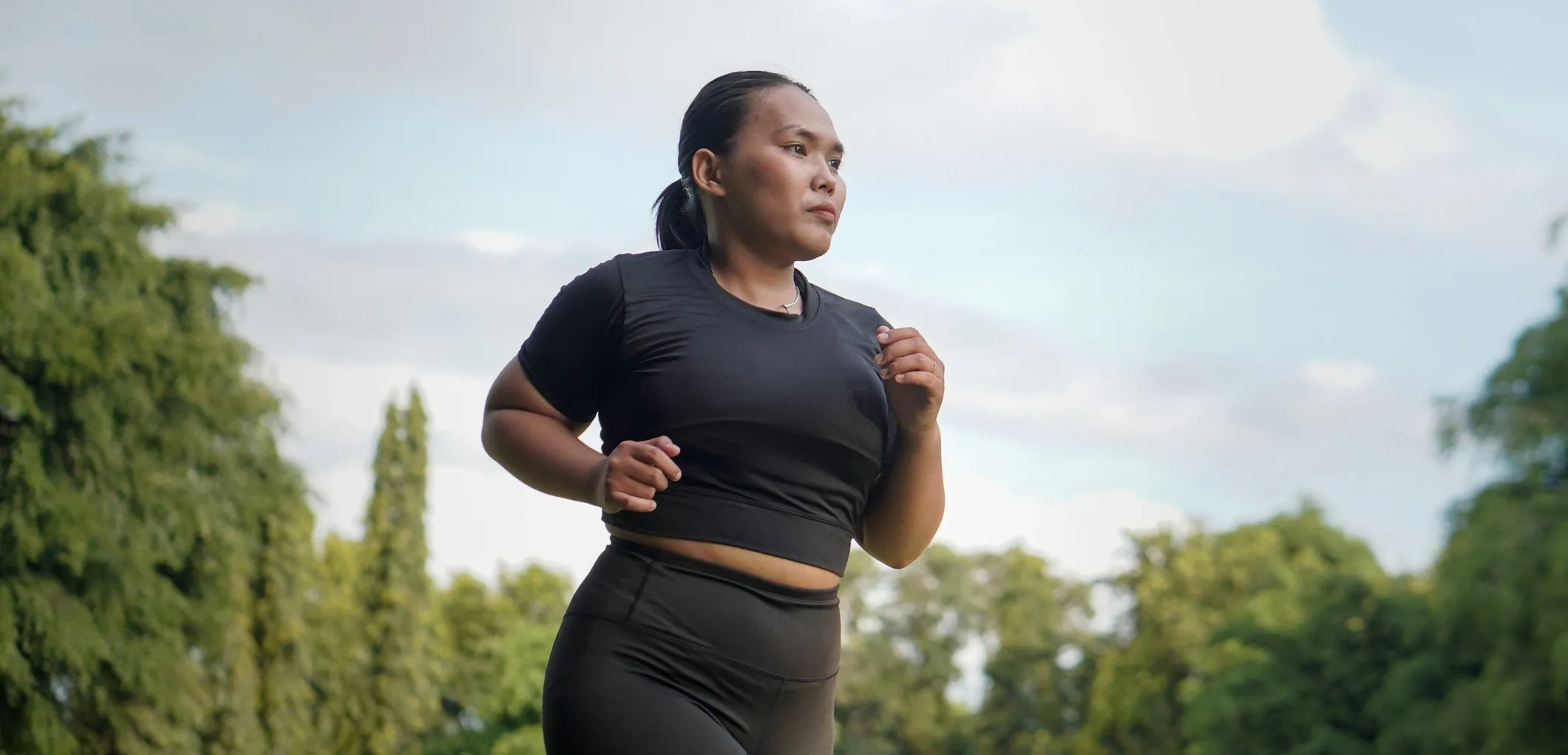 Woman jogging through an open field