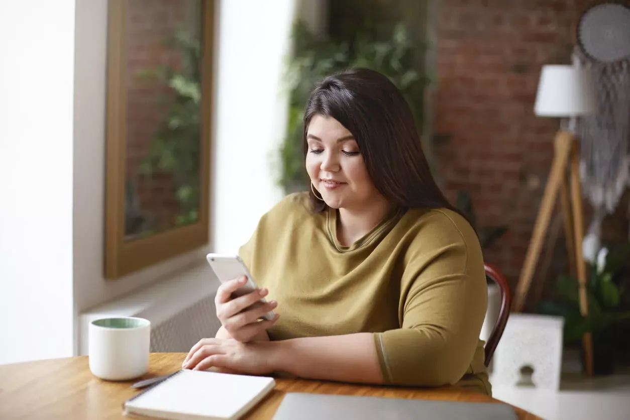 Brunette woman messaging on mobile phone
