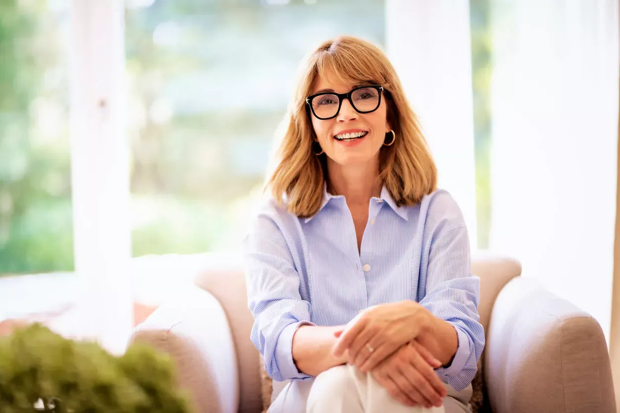 Woman sitting confidently holding notes